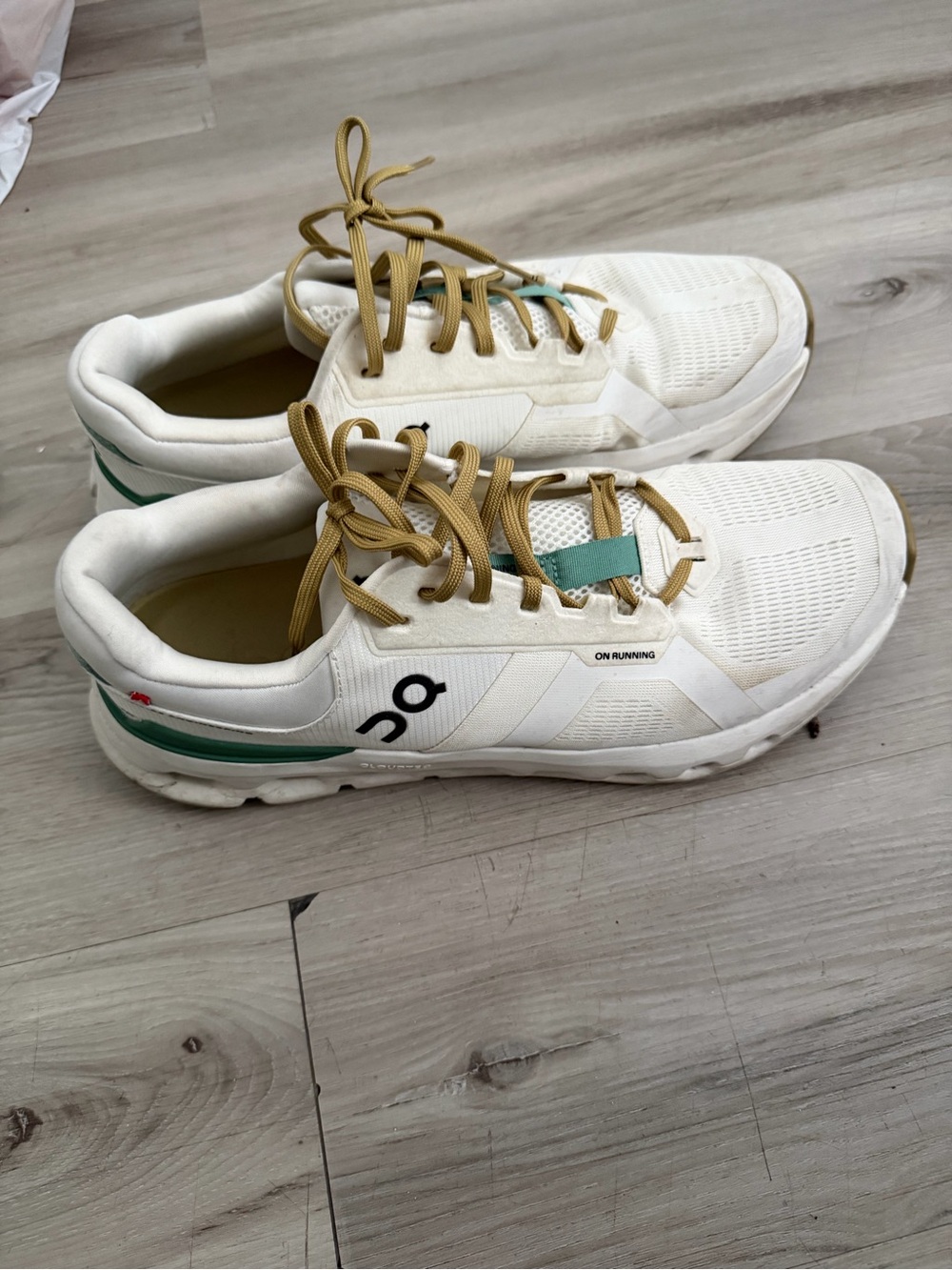 On Running White Athletic Sneakers with Tan Laces and Green Accents